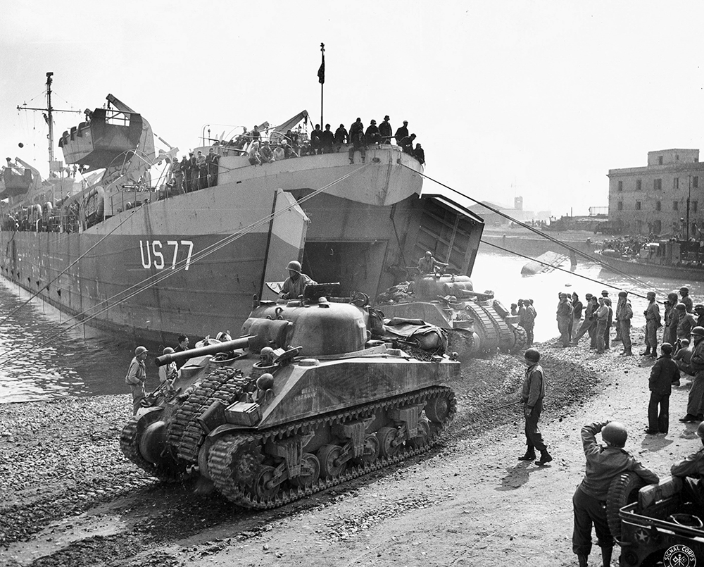 Sherman tanks unloading from LST 77 at Anzio, Italy in May 1944. Sherman tanks unloading from LST 77 at Anzio, Italy in May 1944.