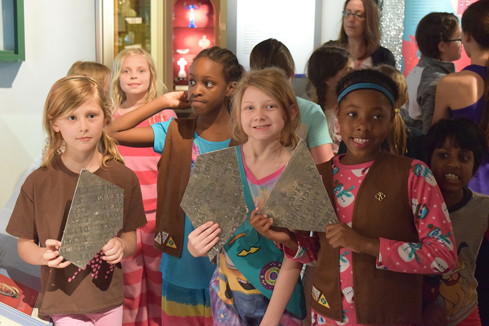 Girl Scouts with the Celeron plate pieces they discovered in the museum.
