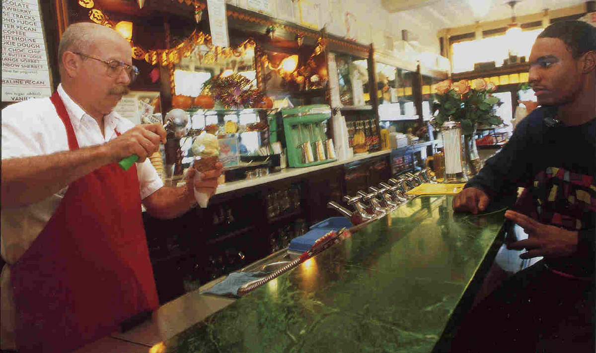 Ray Klavon scoops ice cream for an eager customer. Photo by Heather Mull.