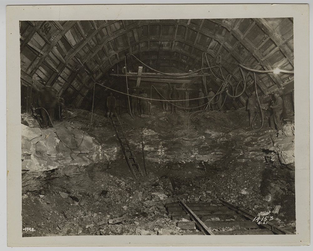 Crews drilling and clearing rock inside the Liberty tunnel shaft, 1920-1921. Heinz History Center.