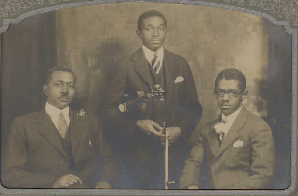 Paul Lawrence Peeler, Sr. holding violin, c. 1920s.