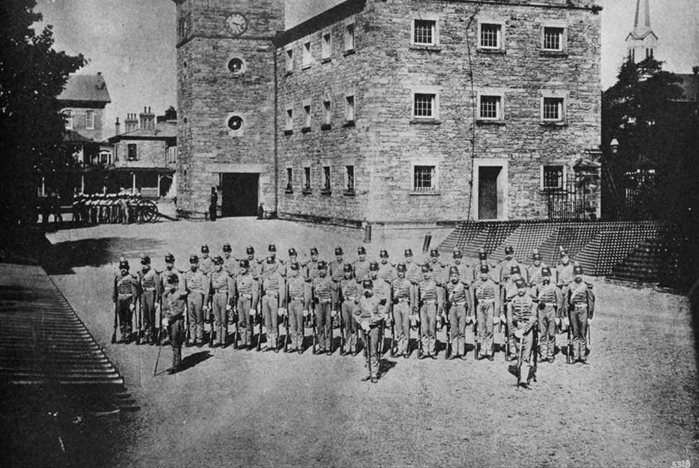 The Duquesne Greys drilled at Allegheny Arsenal in 1870 between rows of surplus cannons and stacks of cannonballs left over from the Civil War.