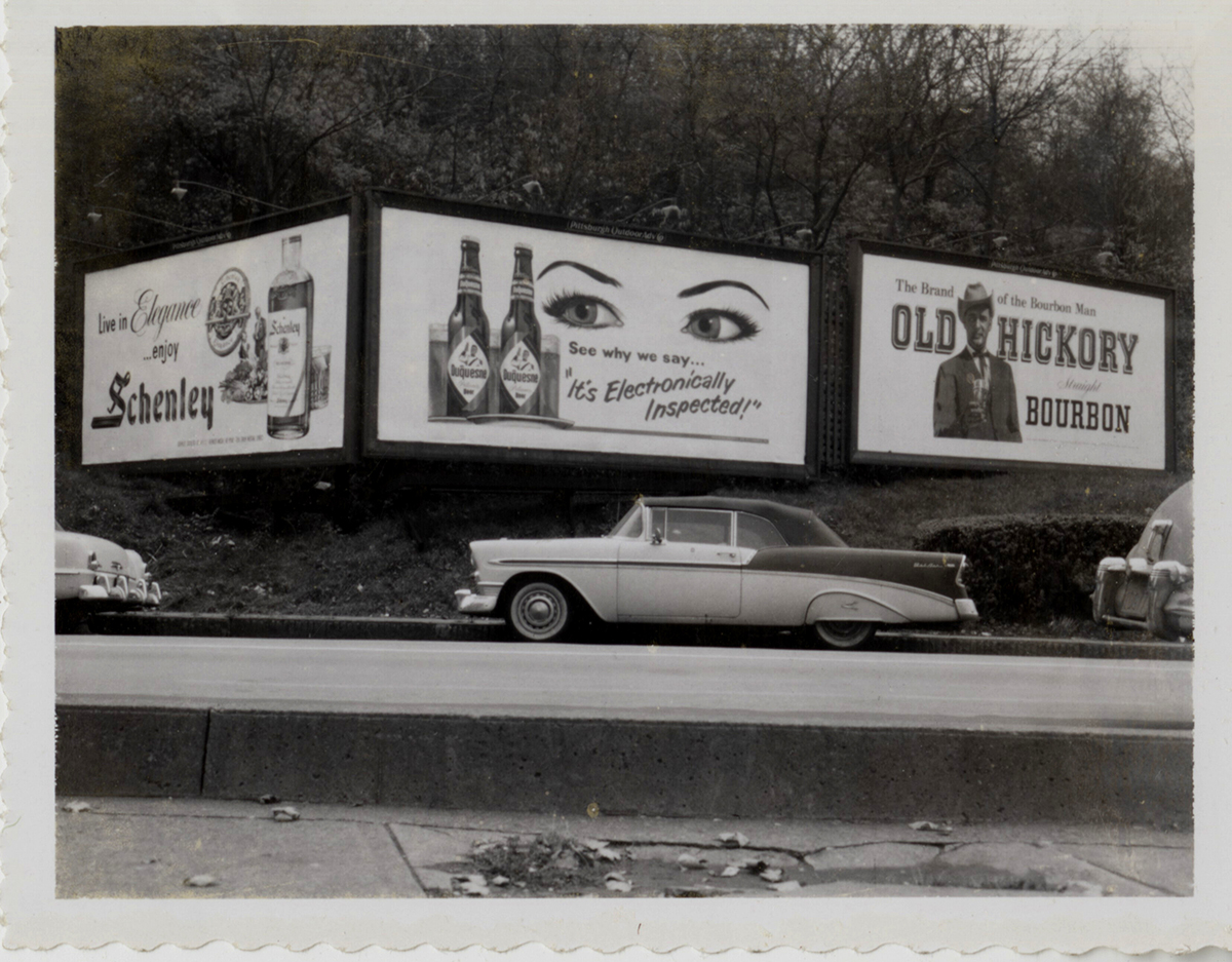 “It’s Electronically Inspected!” Parking along a Duquesne Pilsener billboard, late 1950s. | Heinz History Center