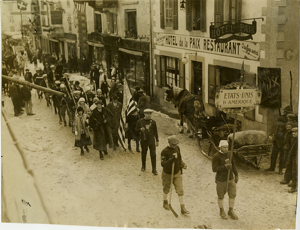 The U.S. team parades through Chamonix, France in the opening ceremonies. Herb Drury leads his team carrying the banner, 1924. Courtesy of Frederick R. Favo.