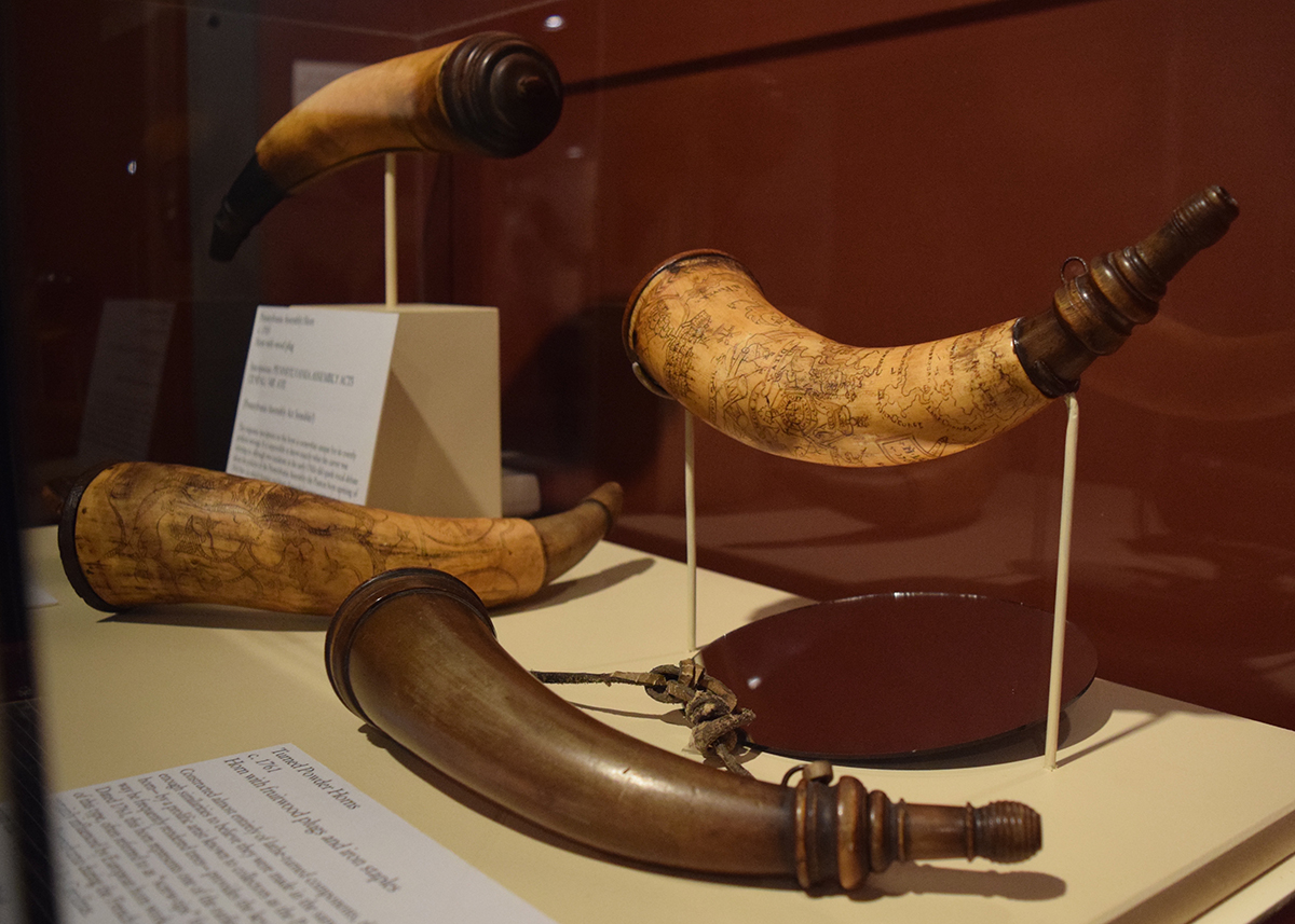 Powder horns likely made in Philadelphia in the second half of the 18th century. While most horns of this type are entirely unmarked, the upper right horn is a rare dated example, made in 1761. One of only a handful with inscriptions, it helps to establish a chronology for the many undated examples, like the horn below it. Background horns courtesy Mr. and Mrs. T.C. Roth; foreground horns courtesy Stephen D. and Marcia P. Hench.