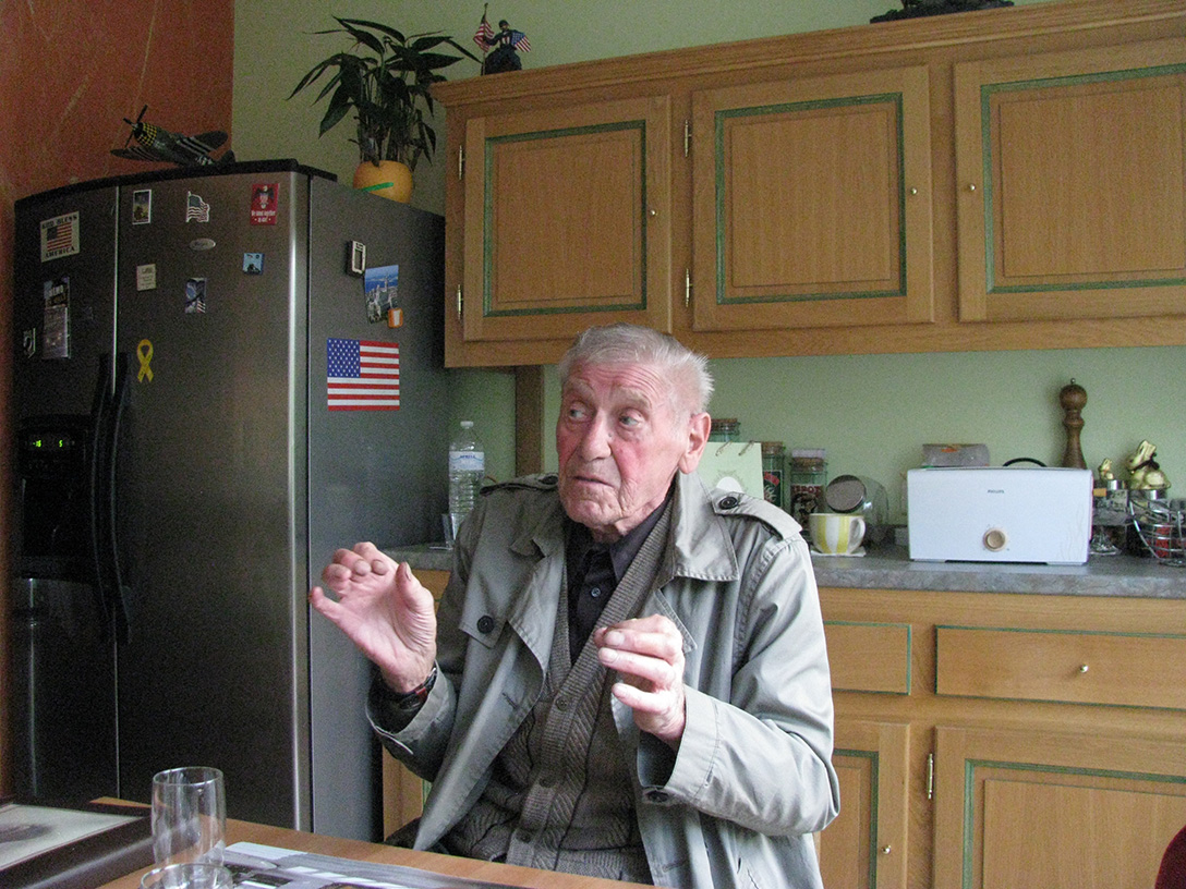 Roger Schneider, himself a French Resistance fighter in World War II and a member of Thanks GIs, tells the story of how he tripped in the woods, accidentally discovering Carl’s remains, almost 90 years after Carl died on the last day of the battle. As he spoke, we knew he had told the story many times before and would continue to tell it proudly. Courtesy of Noretta Willig. Roger Schneider, himself a French Resistance fighter in World War II and a member of Thanks GIs, tells the story of how he tripped in the woods, accidentally discovering Carl’s remains, almost 90 years after Carl died on the last day of the battle. As he spoke, we knew he had told the story many times before and would continue to tell it proudly. Courtesy of Noretta Willig.