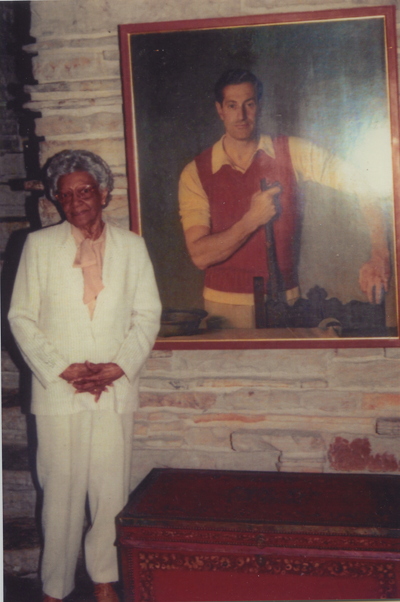 Elsie Henderson stands alongside a portrait of Edgar Kaufmann, Sr. during a visit to Fallingwater. Elsie Henderson Papers and Photographs, Detre Library & Archives, Heinz History Center.