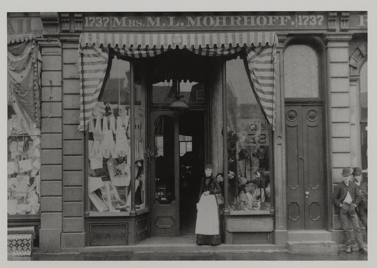 Mary L. Mohrhoff posing in front of her millinery and dressmaking shop on Carson Street