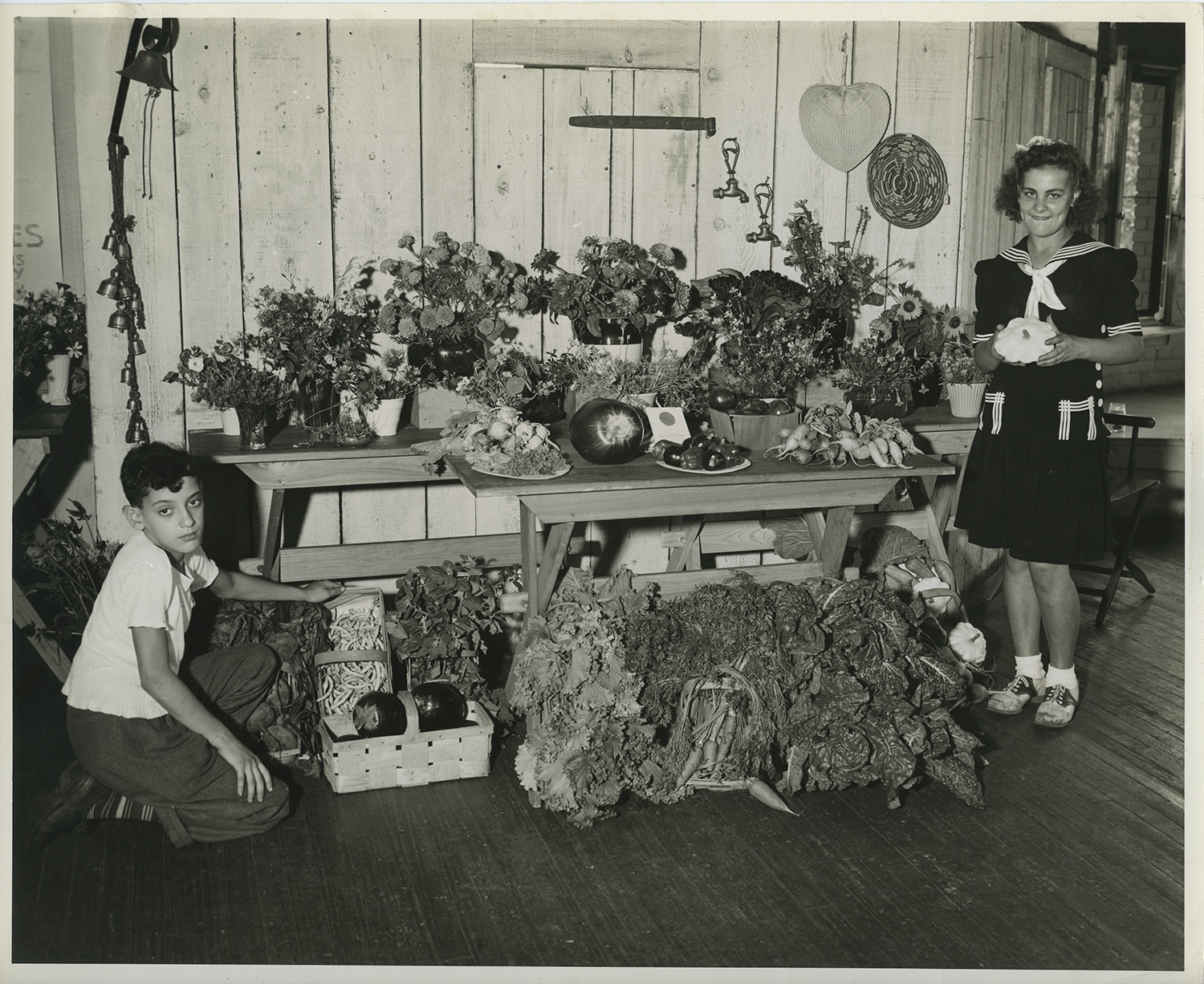 Pittsburgh Public School students pose with the output from one of their gardens, possibly a victory garden, 1940s.