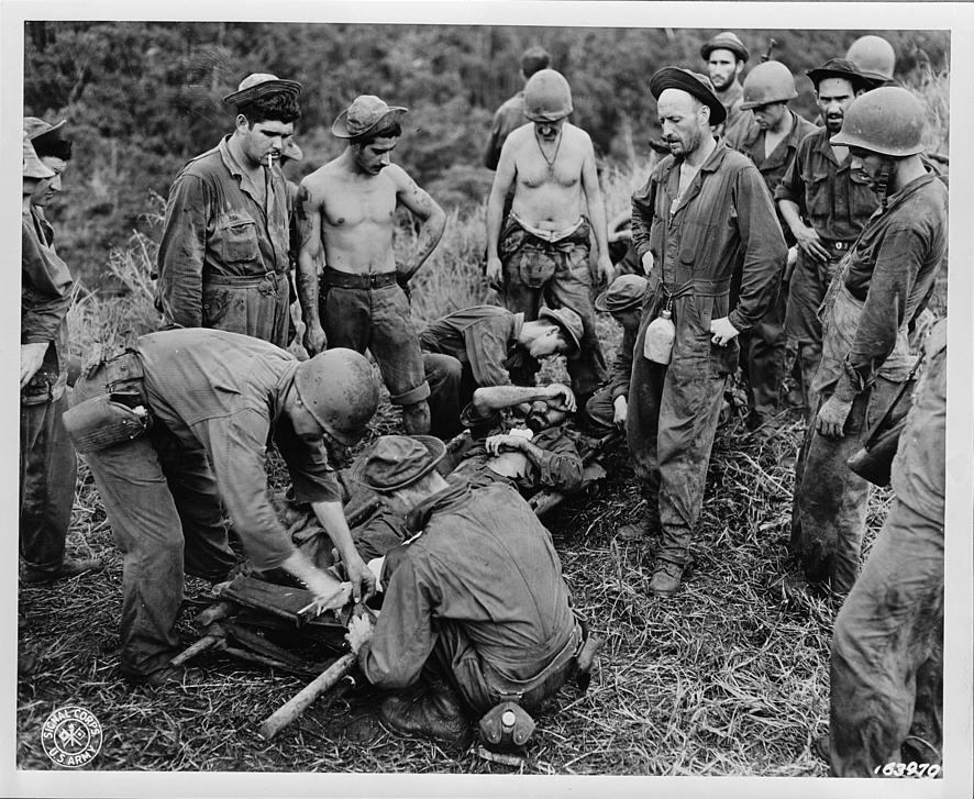 A casualty from the front line being transferred from a makeshift stretcher on Guadalcanal, between 1942-1945. Courtesy of the Office of War Information. Library of Congress, Prints and Photographs Division.