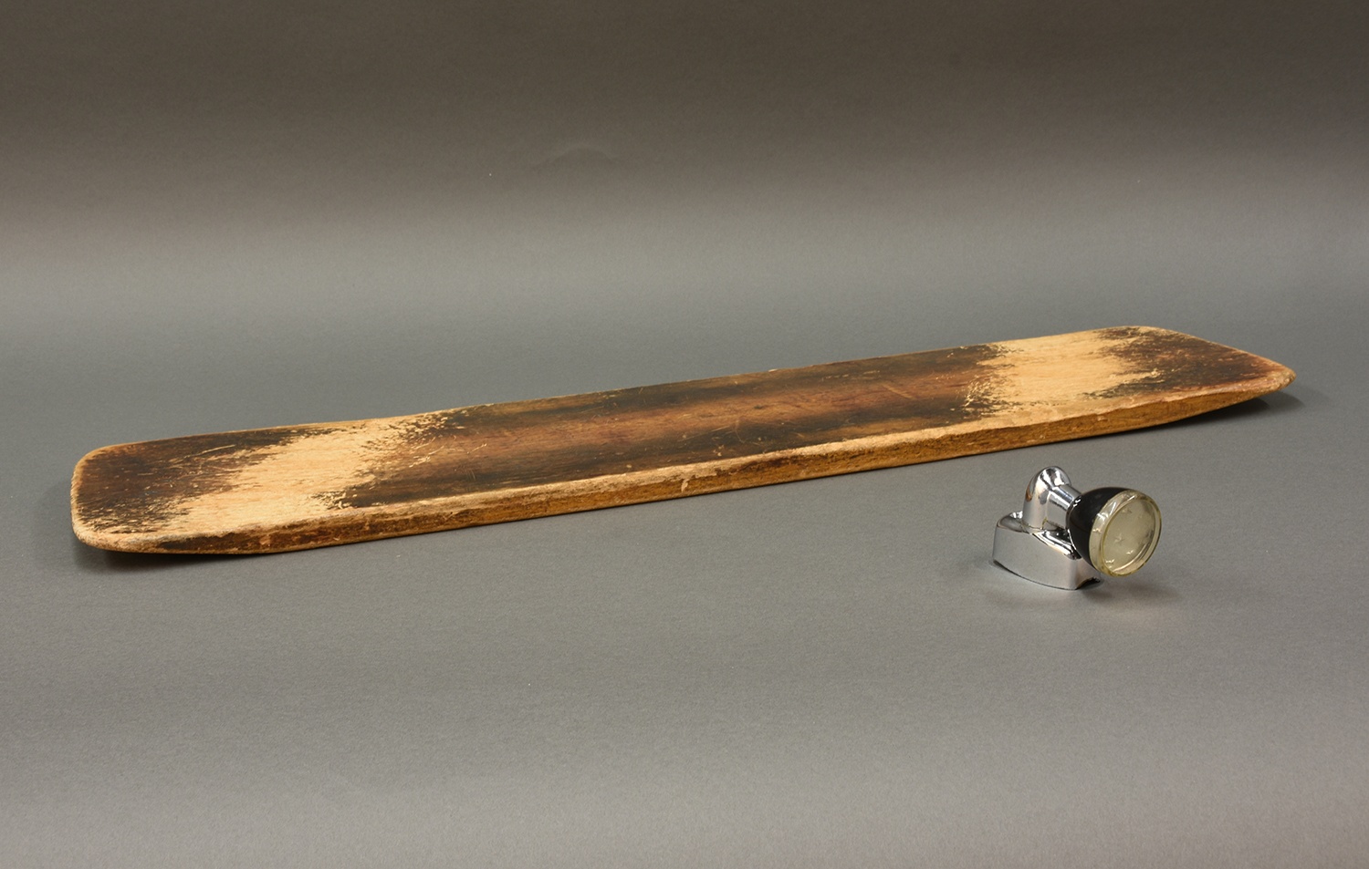 Sliding board that Paul used daily to transfer from his bed into his wheelchair. He also used the board to transfer from his wheelchair into his car, which was retrofitted for his use. The steering wheel knob enabled Paul to turn his steering wheel without the full range of motion of his arm. Gifts of Holly Dick, 2018.138. Sliding board that Paul used daily to transfer from his bed into his wheelchair. He also used the board to transfer from his wheelchair into his car, which was retrofitted for his use. The steering wheel knob enabled Paul to turn his steering wheel without the full range of motion of his arm. Gifts of Holly Dick, 2018.138.