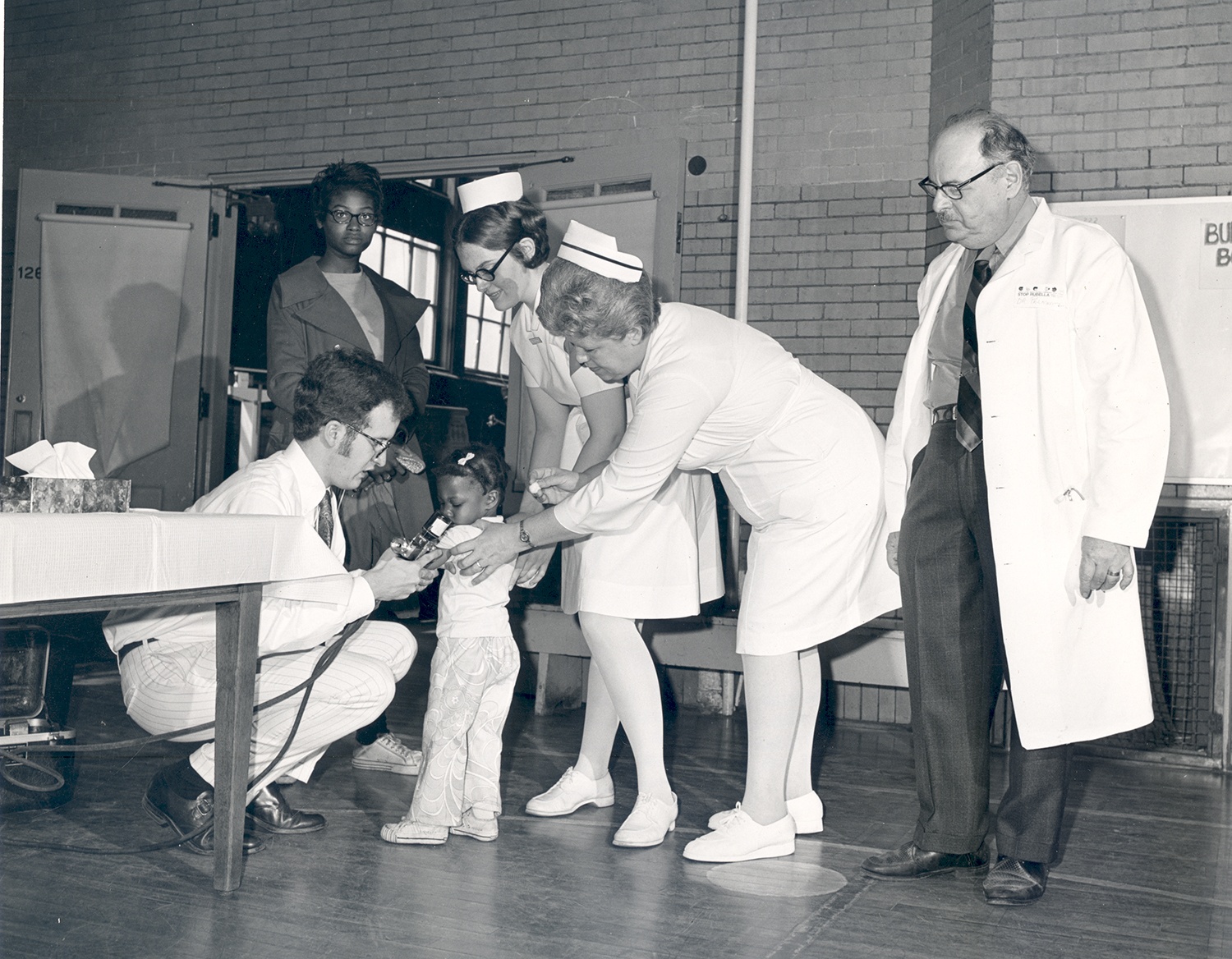 A child at Gladstone School receives a vaccination during Allegheny County’s Rubella Campaign, Vinard Studios, c. 1970.