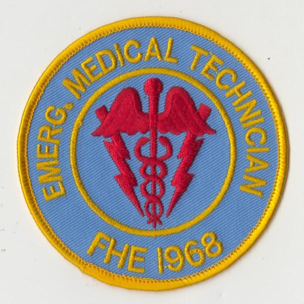 Reproduction of patch for uniform, Emergency Medical Technician, Freedom House. The emblem patch of Freedom House includes the two headed caduceus medical symbol. Worn on the left breast of the uniform, this patch indicated that the technician had completed a rigorous training course, the first of its kind in the U.S. Gift of John L. Moon.