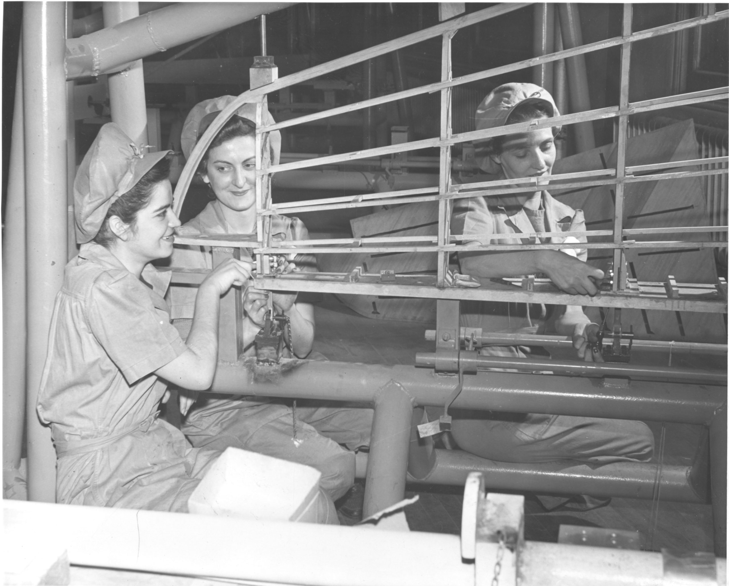 L to R: Margaret Nagy, Grace Slomar, Irene Hays work to assemble parts of a wing at Heinz, 1942-1943.