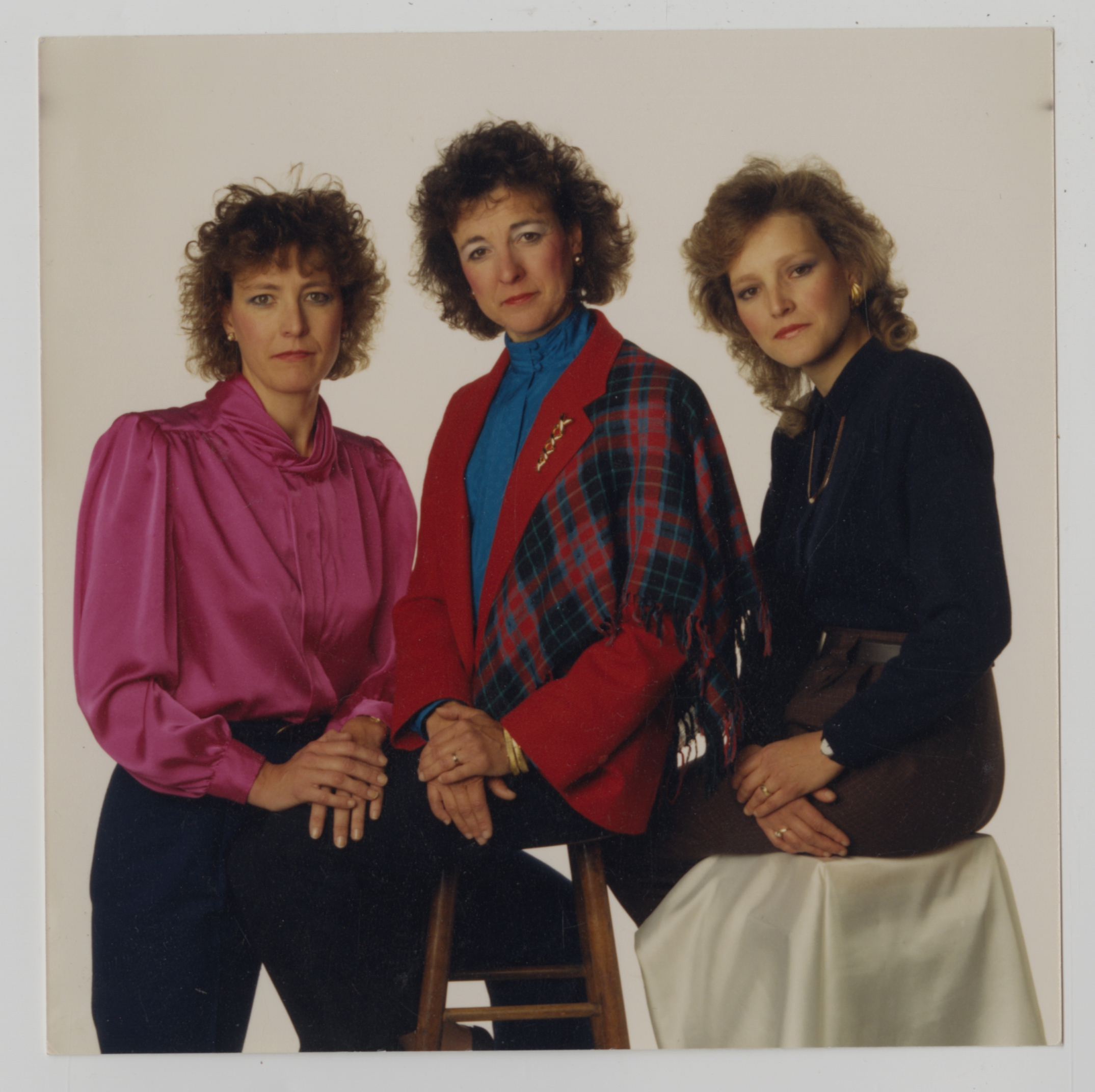 The three McGinnis Sisters posing together for a portrait.