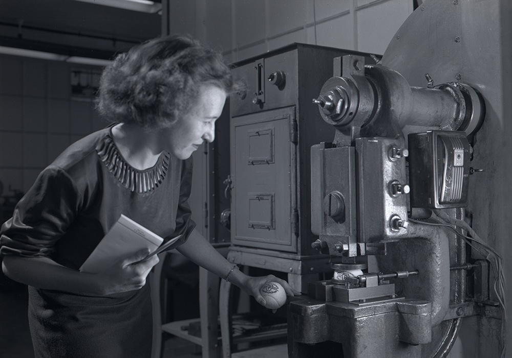 Pennsylvania Rubber Company employee testing a tennis ball, 1947