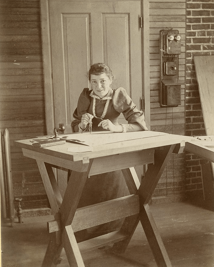 Bertha Lamme sits at a work table.