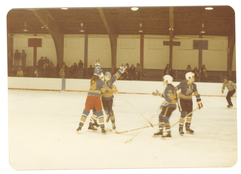 Group of players on the Pennies huddled on the ice.