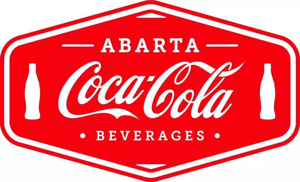 Red and white Abarta Coca-Cola Beverages logo in a hexagonal badge shape, featuring the classic Coca-Cola script in the center with bold white lettering; two small illustrated Coke bottles positioned on each side of the script.