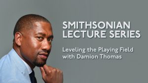 A man wearing a light blue suit stands with his hand resting on his chin in a thoughtful pose. The background is gray. White text reads: Smithsonian Lecture Series. Leveling the Playing Field with Damion Thomas.