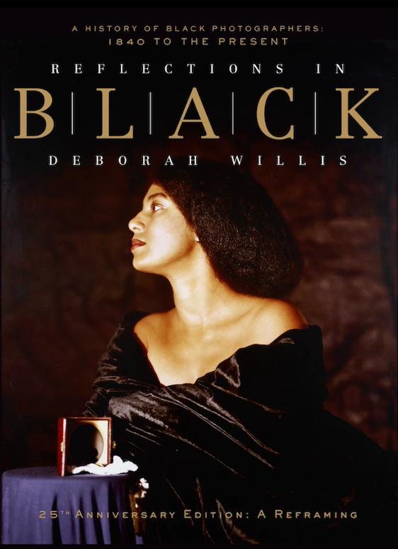 Book cover titled Reflections in Black by Deborah Willis, depicting a Black woman in an elegant dress beside a framed photograph. *AI generated alt text