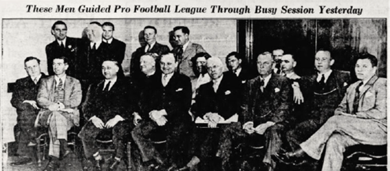 Black-and-white photo of 18 men in suits, seated and standing in two rows. Caption: These Men Guided Pro Football League Through Busy Session Yesterday. *AI generated alt text
