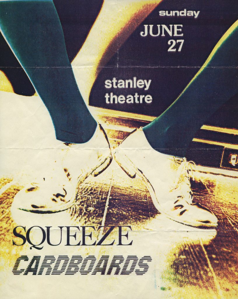 A vintage-style poster with two pairs of feet in white shoes, touching toes. Text: “Sunday June 27, Stanley Theatre. Squeeze. Cardboards.” in bold black and white letters. *AI generated alt text