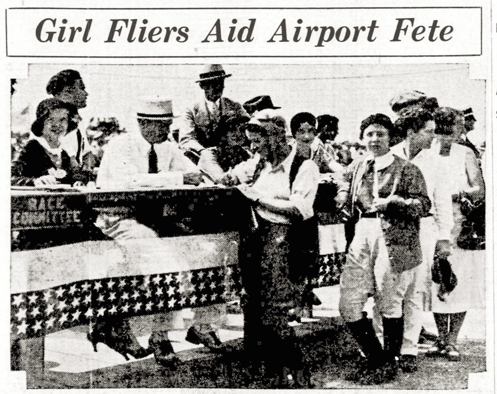 Black-and-white photograph showing women pilots in aviation uniforms seated at a decorated table with a Race Committee sign, interacting with men and women during an airport event. The scene takes place indoors, and a newspaper headline above them reads: Girl Fliers Aid Airport Fete. *AI generated alt text