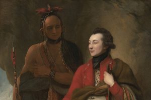 A Native American man stands beside a seated European man dressed in colonial-era clothing. Both are shown in detailed attire, with Fort Pitt and an active landscape featuring multiple figures in the background. *AI generated alt text