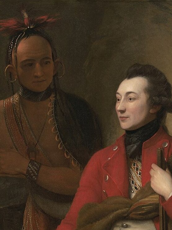 A Native American man stands beside a seated European man dressed in colonial-era clothing. Both are shown in detailed attire, with Fort Pitt and an active landscape featuring multiple figures in the background. *AI generated alt text